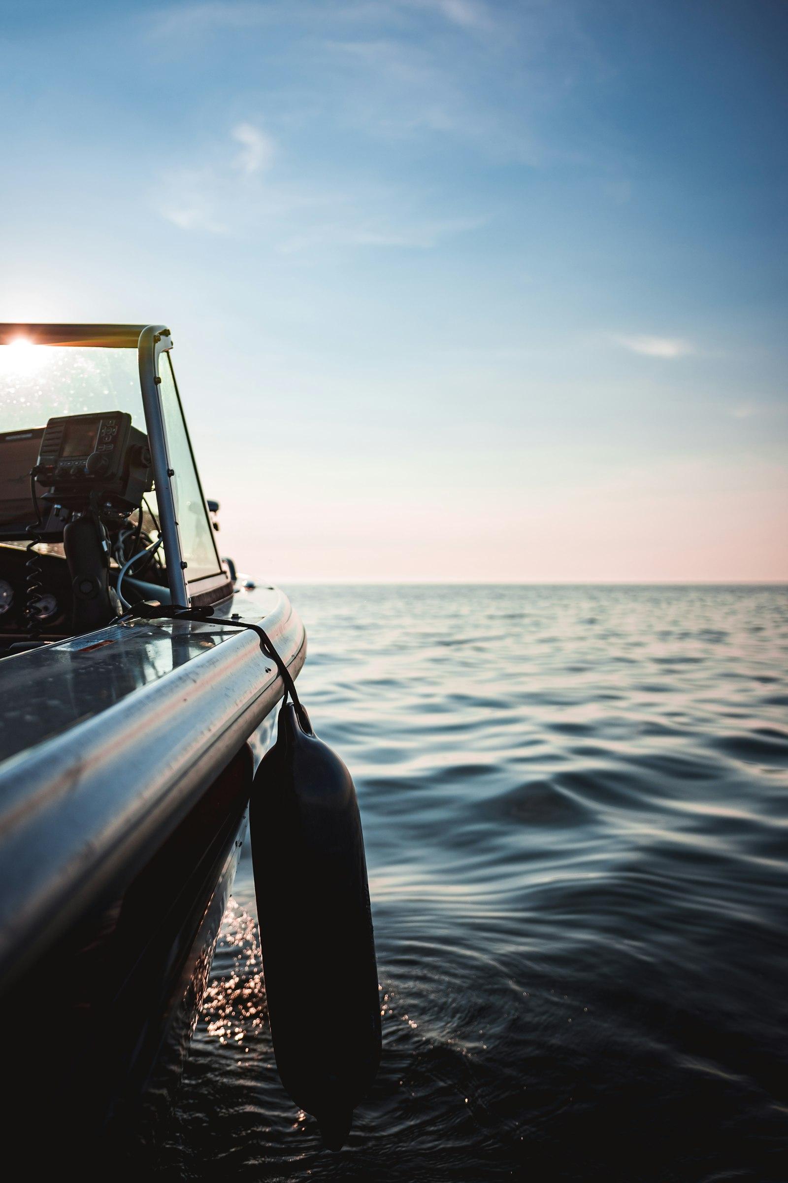 Boat helm at sunset on calm water — the moment after the charter when the guest relationship still matters