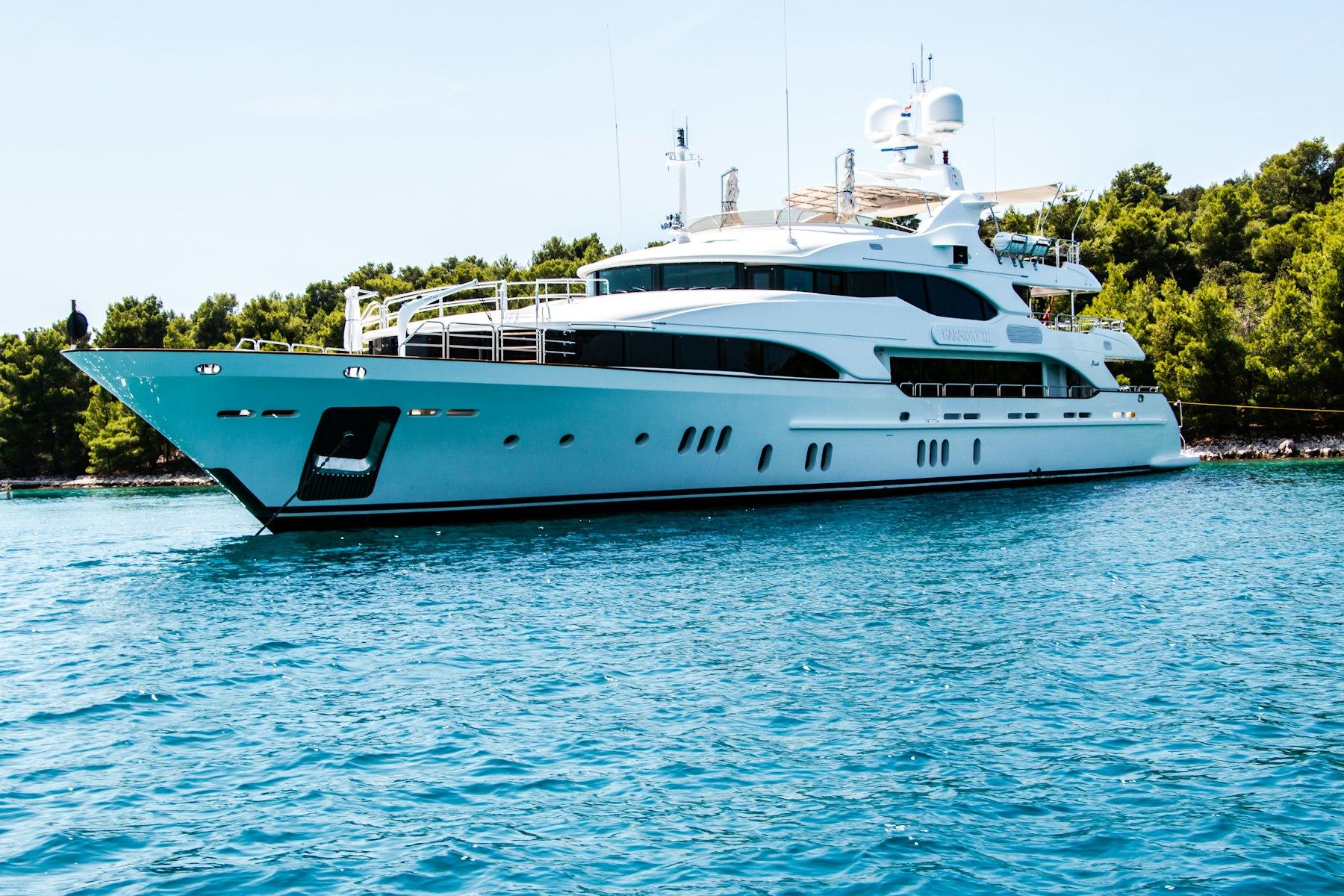 Private crewed motor yacht on clear water — day-charter inventory Slipstack books as packages